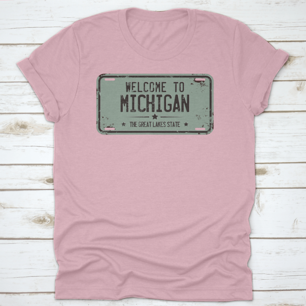 A stylish cotton t-shirt featuring a damaged license plate design with the message 'Welcome To Michigan', showcasing its comfortable fit and quality fabric.