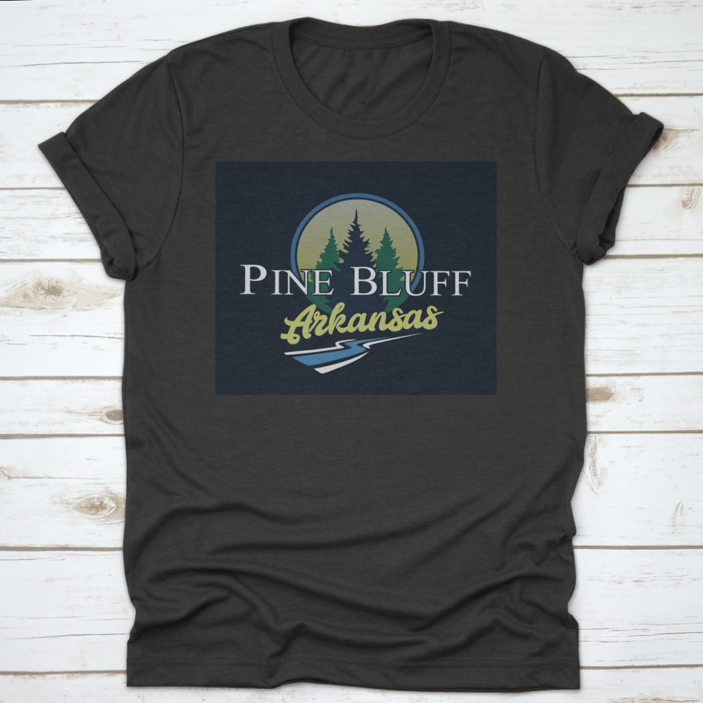 A stylish cotton t-shirt featuring a nature-inspired design representing Pine Bluff, Arkansas, showcasing trees, wood, and water elements.