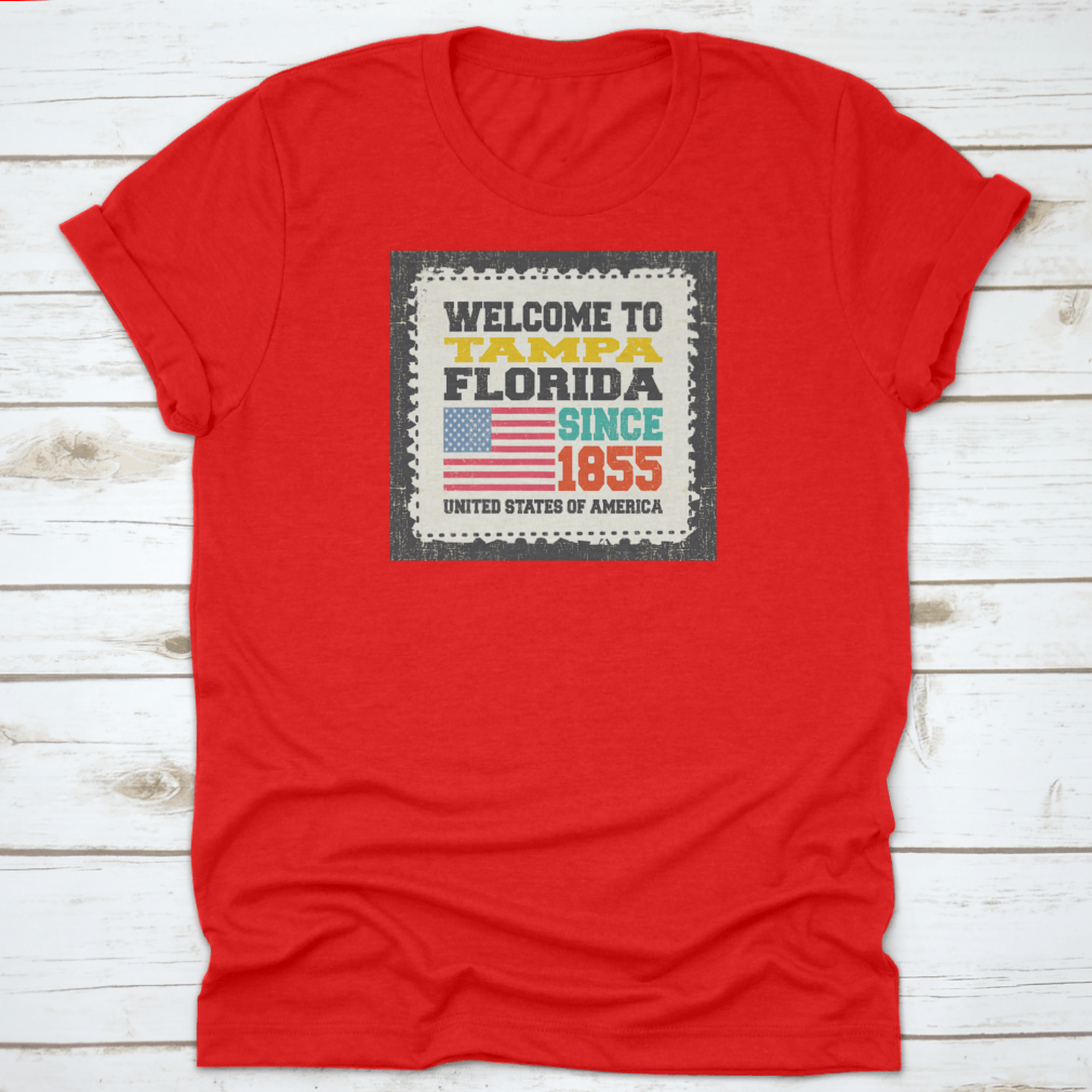 A classic cotton t-shirt featuring the phrase 'Welcome To Tampa, State Florida. Since 1855' with an American flag design.