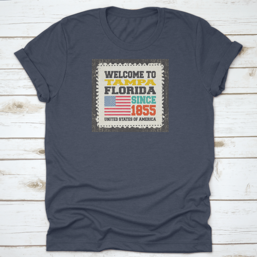 A classic cotton t-shirt featuring the phrase 'Welcome To Tampa, State Florida. Since 1855' with an American flag design.