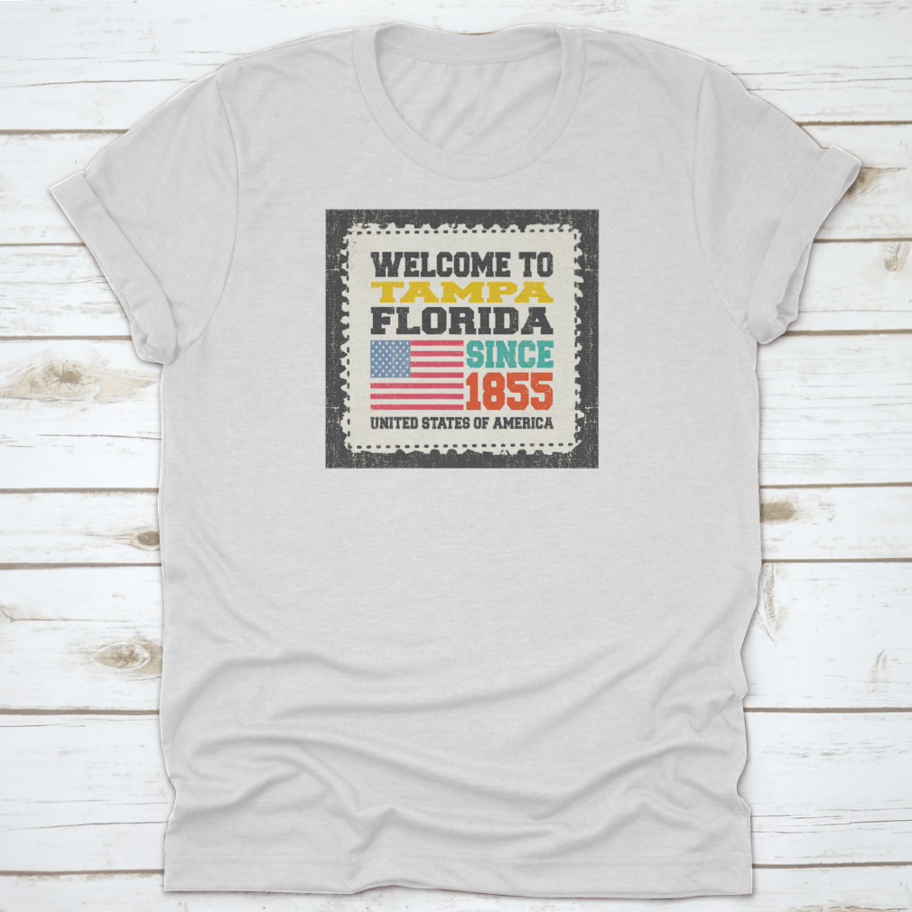 A classic cotton t-shirt featuring the phrase 'Welcome To Tampa, State Florida. Since 1855' with an American flag design.