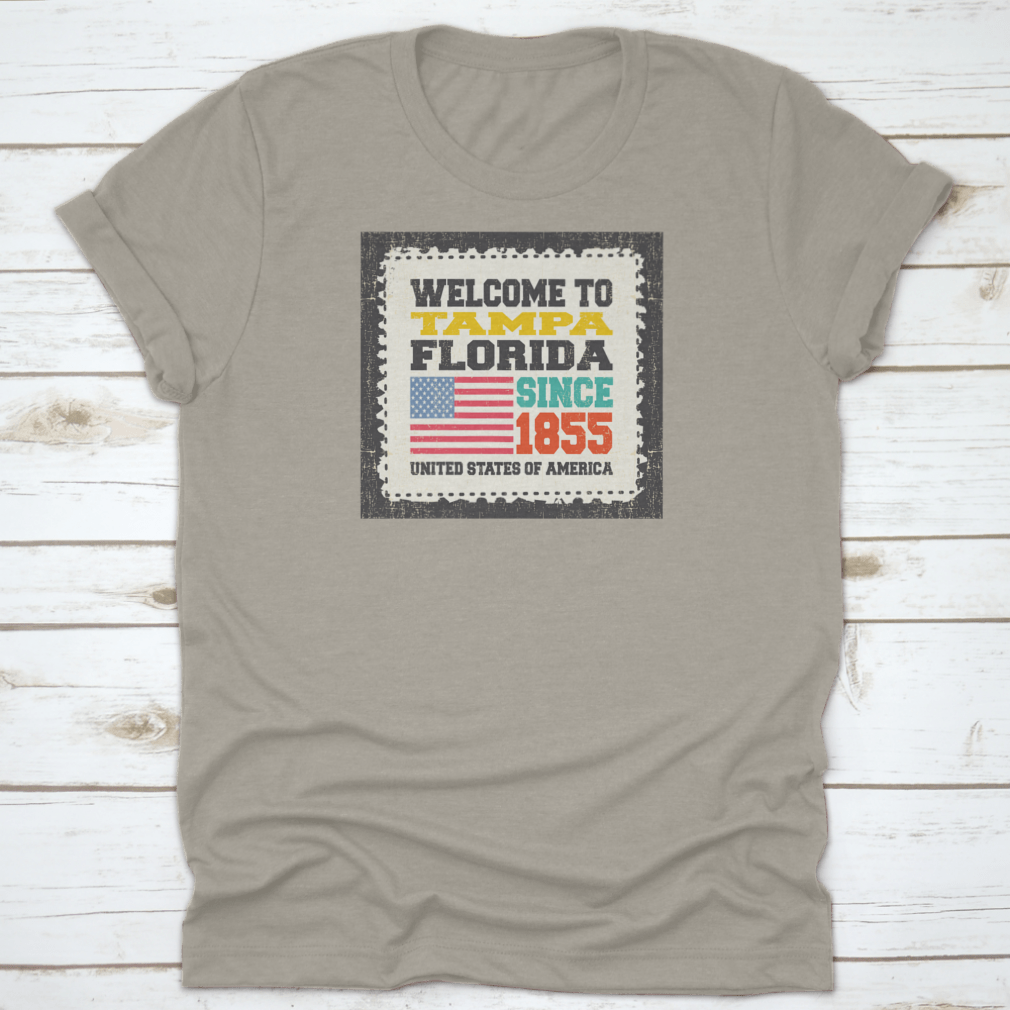 A classic cotton t-shirt featuring the phrase 'Welcome To Tampa, State Florida. Since 1855' with an American flag design.