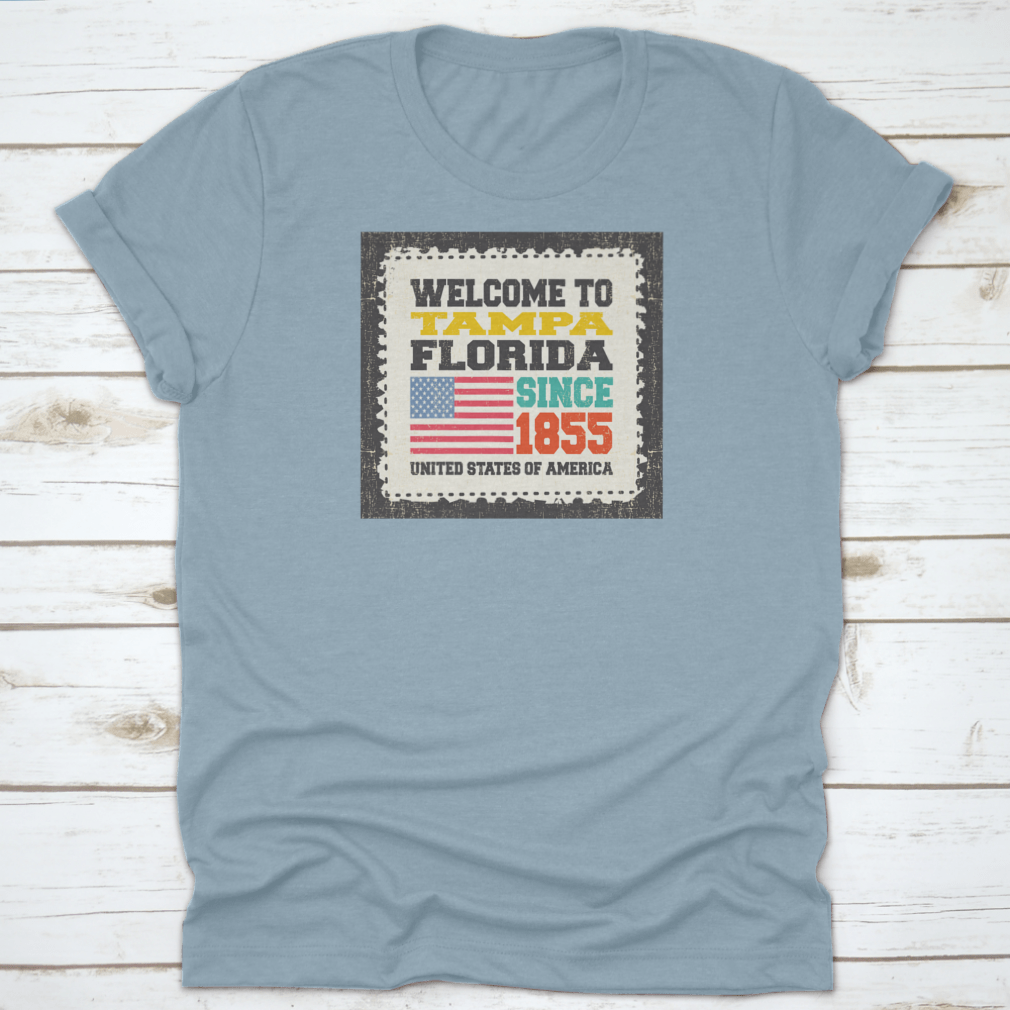 A classic cotton t-shirt featuring the phrase 'Welcome To Tampa, State Florida. Since 1855' with an American flag design.