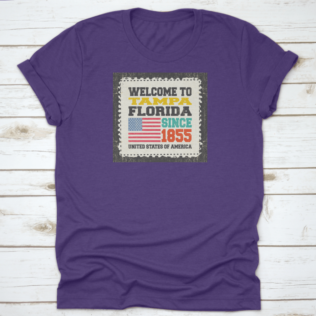 A classic cotton t-shirt featuring the phrase 'Welcome To Tampa, State Florida. Since 1855' with an American flag design.