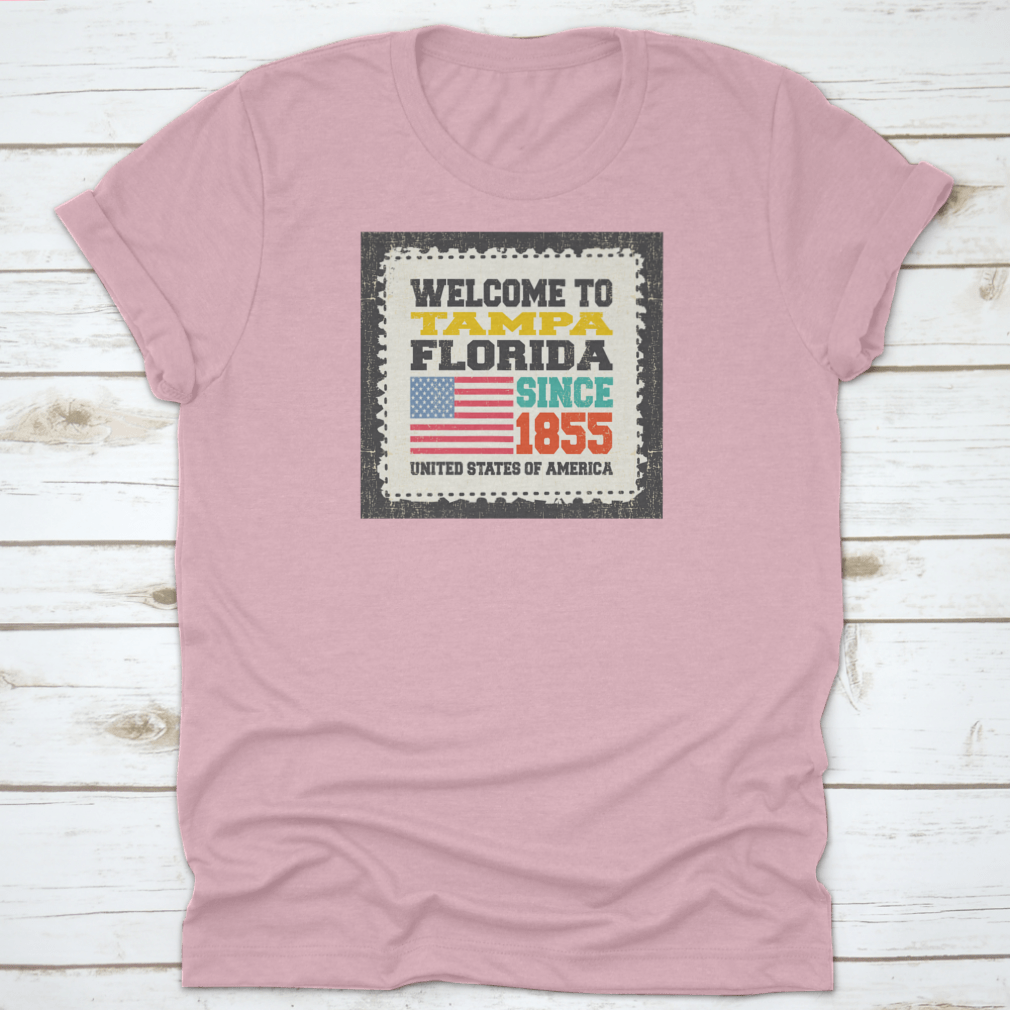A classic cotton t-shirt featuring the phrase 'Welcome To Tampa, State Florida. Since 1855' with an American flag design.