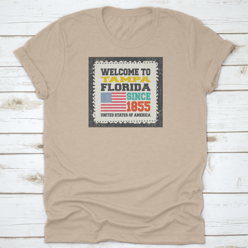 A classic cotton t-shirt featuring the phrase 'Welcome To Tampa, State Florida. Since 1855' with an American flag design.