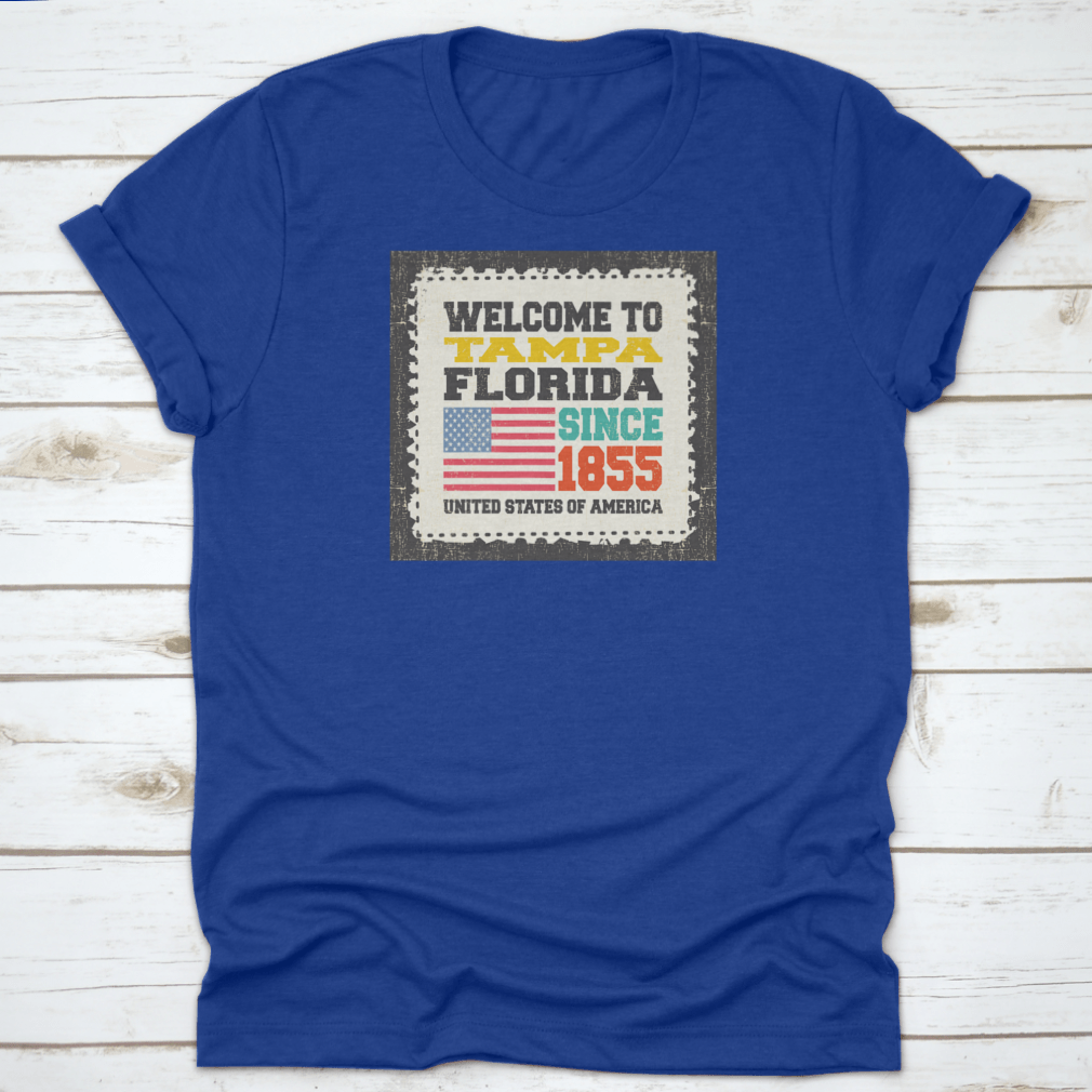 A classic cotton t-shirt featuring the phrase 'Welcome To Tampa, State Florida. Since 1855' with an American flag design.