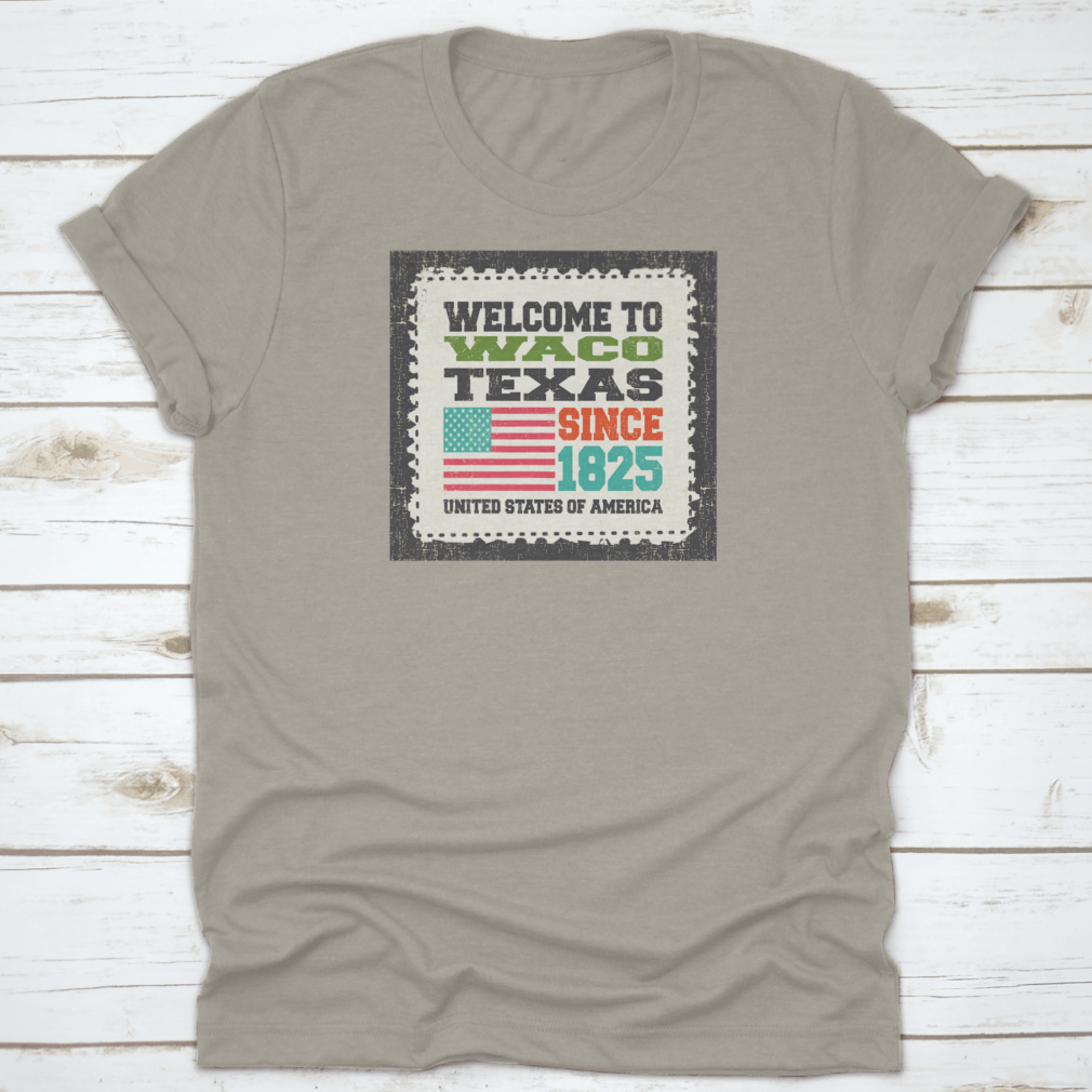 A stylish cotton t-shirt featuring the phrase 'Welcome To Waco State Texas Since 1825' with an American flag design, perfect for travel enthusiasts.