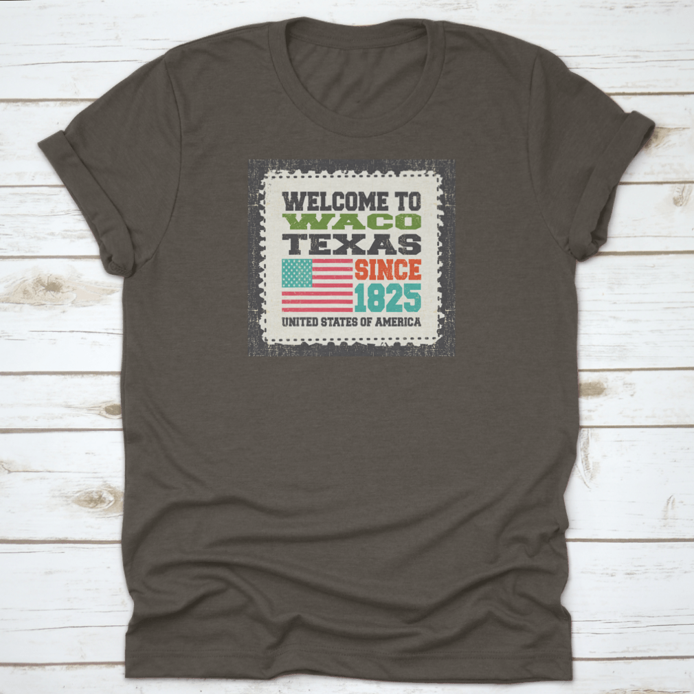 A stylish cotton t-shirt featuring the phrase 'Welcome To Waco State Texas Since 1825' with an American flag design, perfect for travel enthusiasts.