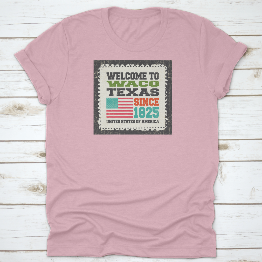 A stylish cotton t-shirt featuring the phrase 'Welcome To Waco State Texas Since 1825' with an American flag design, perfect for travel enthusiasts.