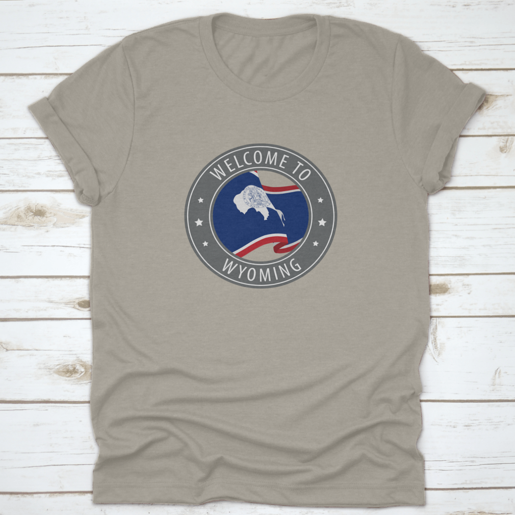 Gray t-shirt featuring a waving Wyoming state flag design, made from 100% cotton for comfort.