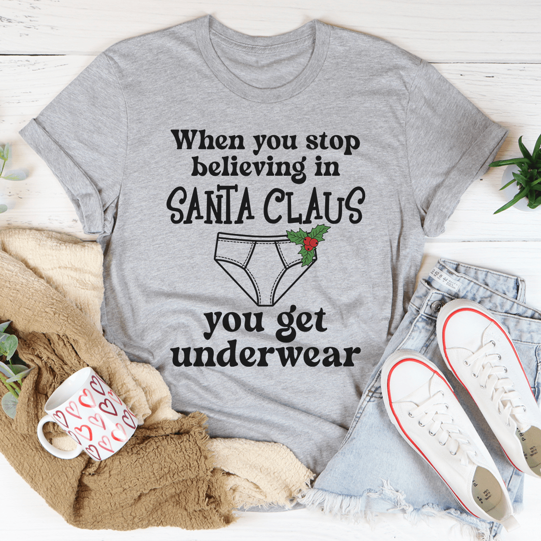 A festive tee featuring the phrase 'When You Stop Believing In Santa Claus', made from 100% soft cotton with a vibrant digital print.