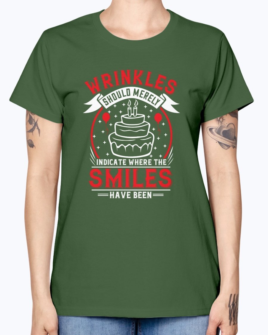 A stylish women's t-shirt featuring the quote 'Wrinkles should merely indicate where the smiles have been' in a cheerful font, perfect for birthday celebrations.