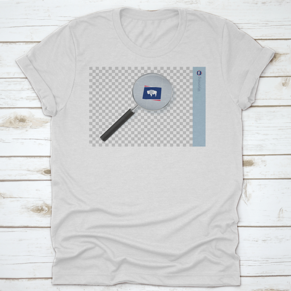 A stylish shirt featuring a Wyoming map and flag design inside a magnifying glass, showcasing state pride.