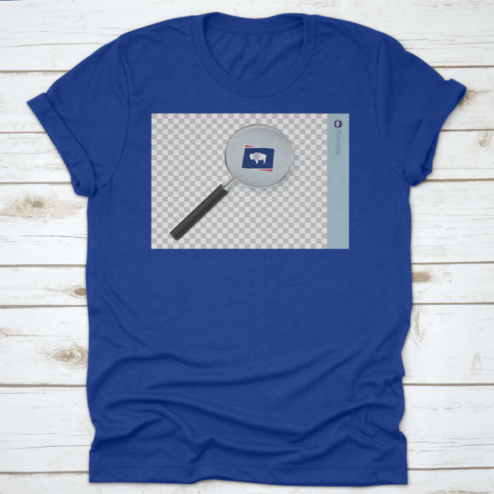 A stylish shirt featuring a Wyoming map and flag design inside a magnifying glass, showcasing state pride.