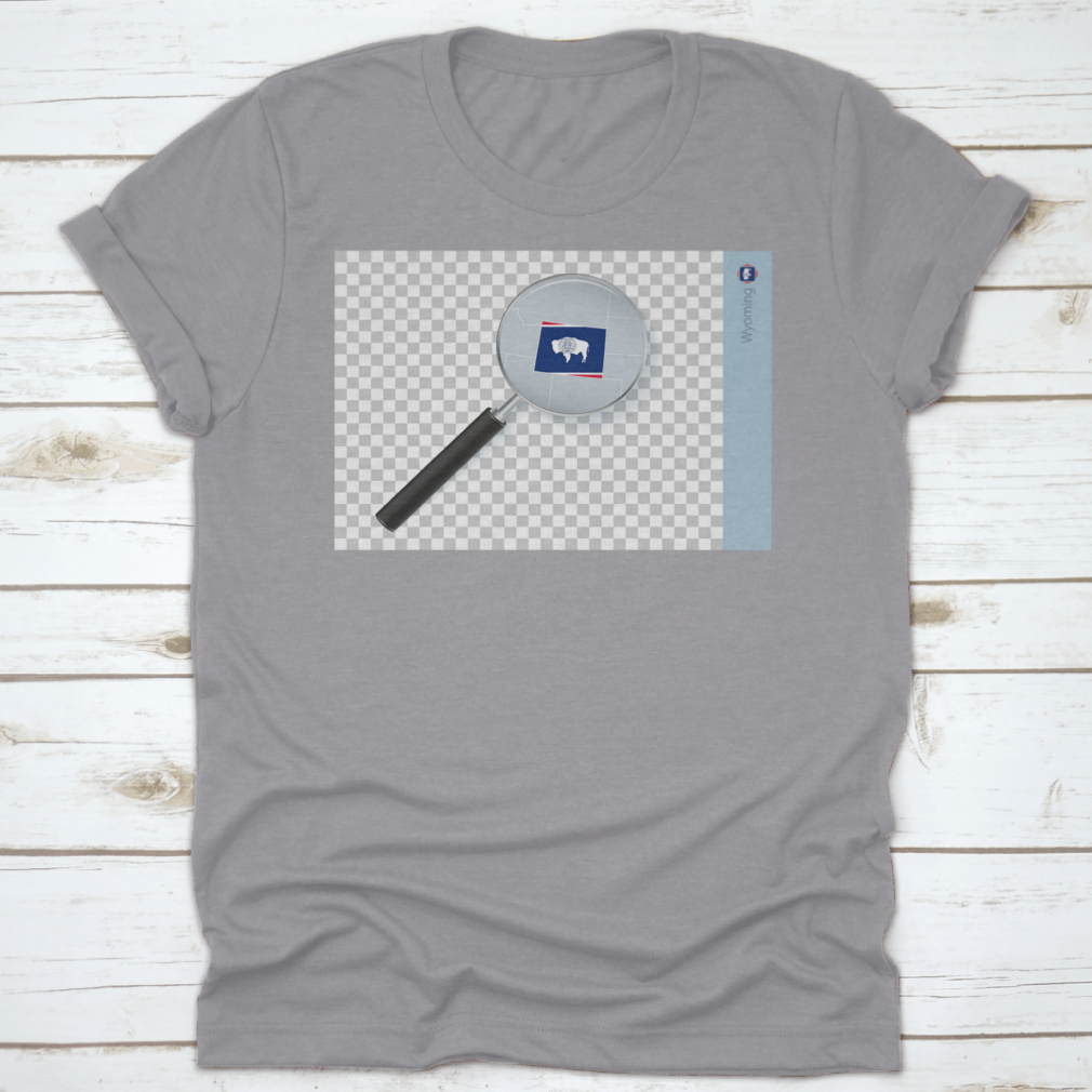A stylish shirt featuring a Wyoming map and flag design inside a magnifying glass, showcasing state pride.