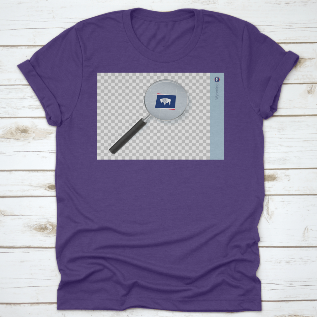A stylish shirt featuring a Wyoming map and flag design inside a magnifying glass, showcasing state pride.
