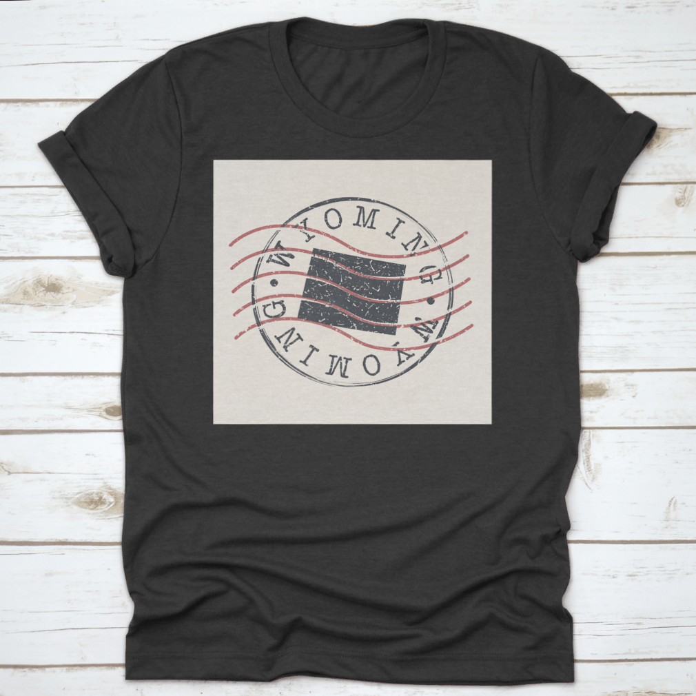 A stylish Wyoming Stamp Postal t-shirt featuring a map silhouette seal design, made from soft cotton fabric.