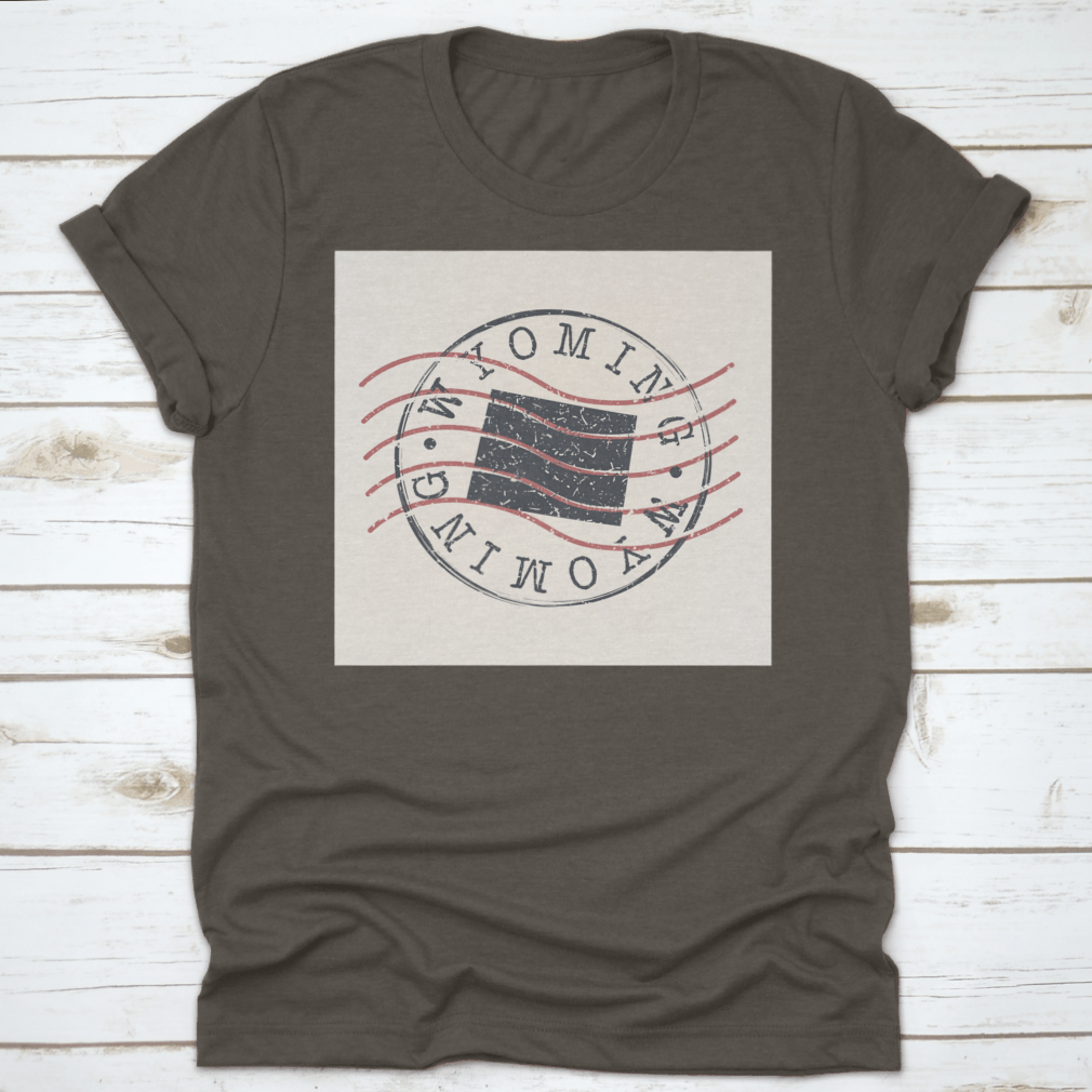 A stylish Wyoming Stamp Postal t-shirt featuring a map silhouette seal design, made from soft cotton fabric.