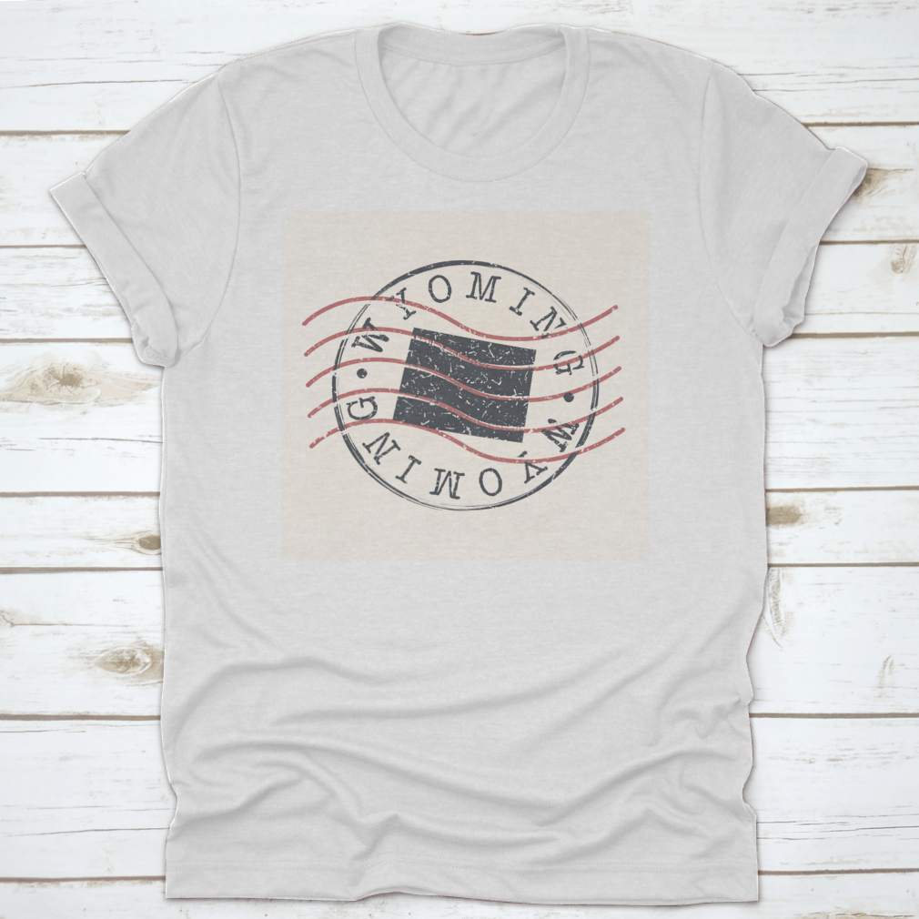 A stylish Wyoming Stamp Postal t-shirt featuring a map silhouette seal design, made from soft cotton fabric.
