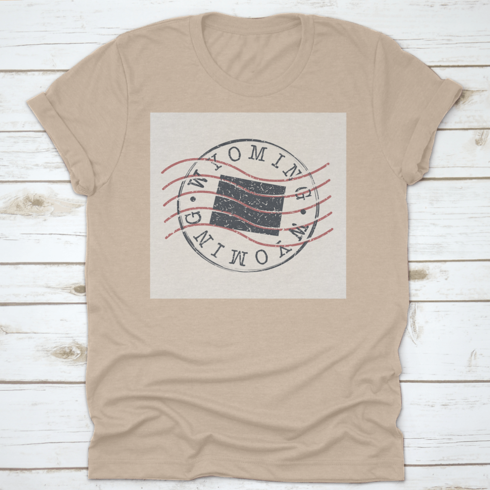 A stylish Wyoming Stamp Postal t-shirt featuring a map silhouette seal design, made from soft cotton fabric.