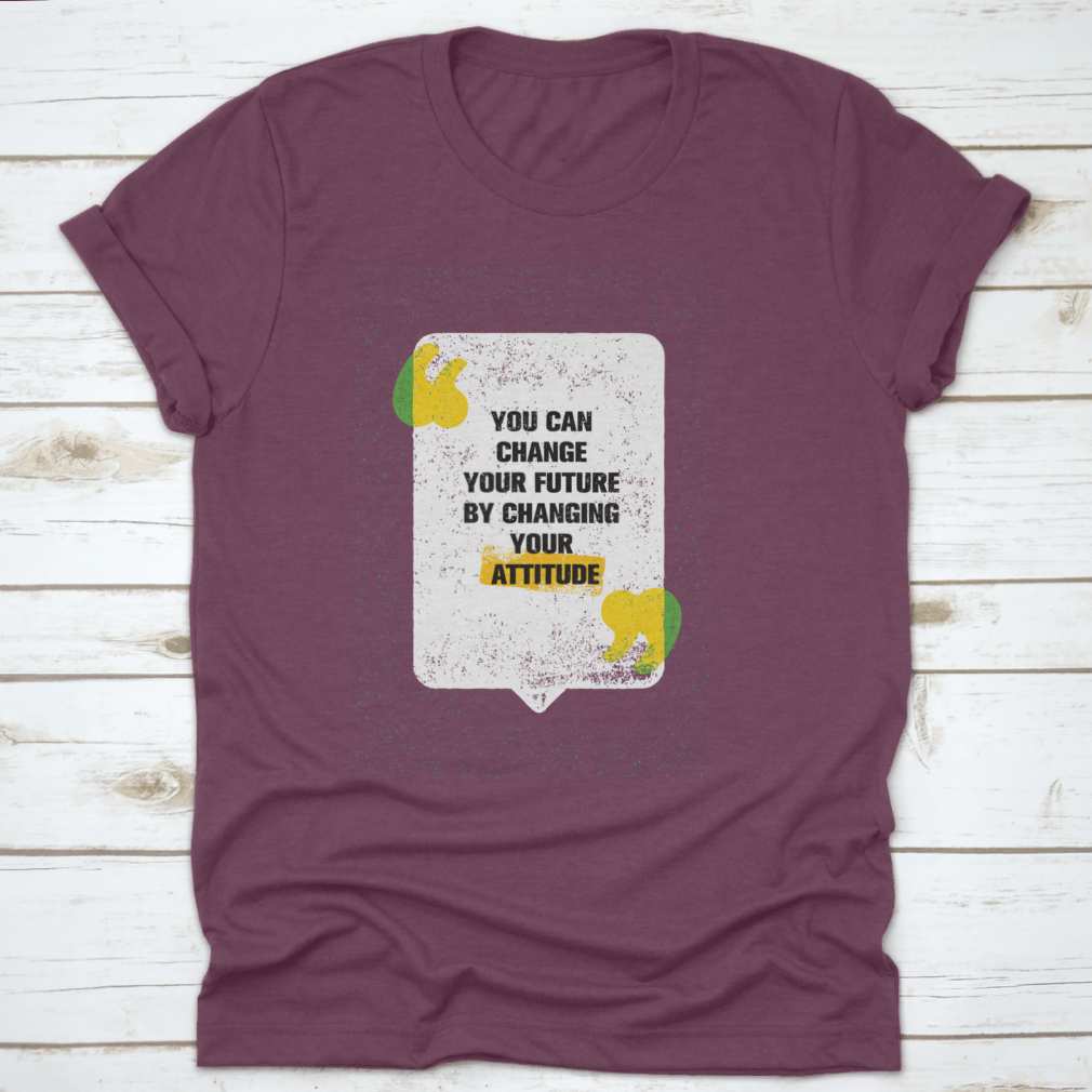 A modern t-shirt featuring the motivational phrase 'You Can Change Your Future By Changing Your Attitude', made from soft cotton fabric.