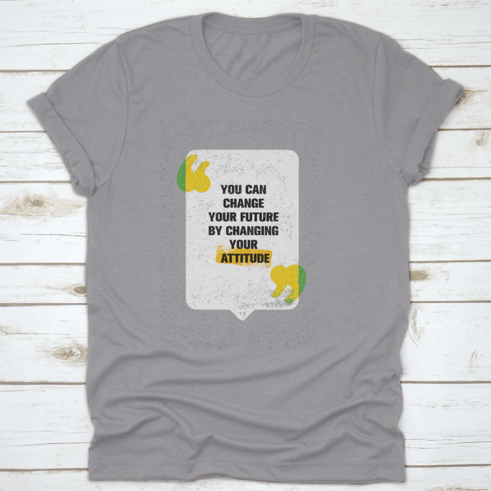 A modern t-shirt featuring the motivational phrase 'You Can Change Your Future By Changing Your Attitude', made from soft cotton fabric.