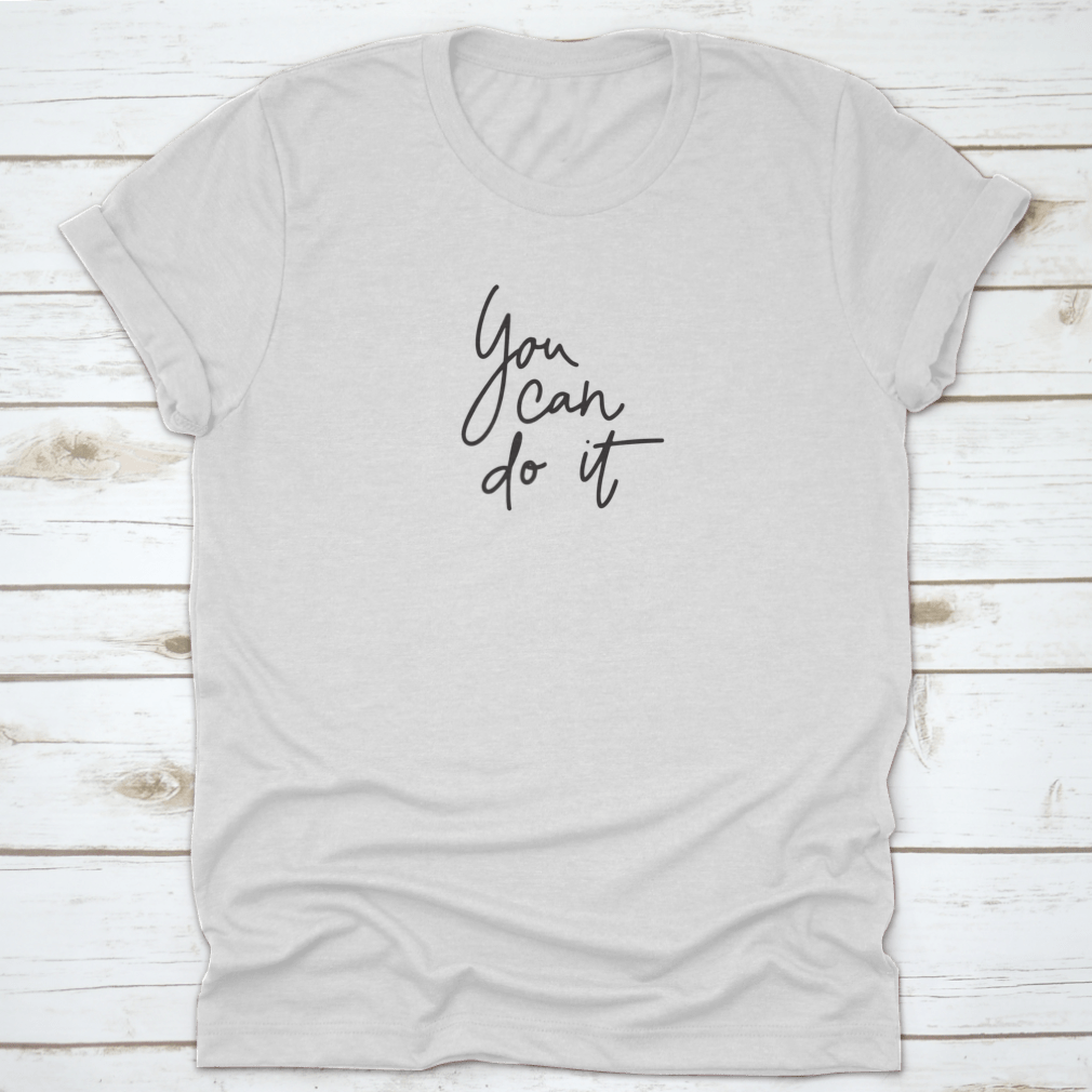 A stylish T-shirt featuring the inspirational quote 'You Can Do It' in hand lettering, made from soft cotton fabric.