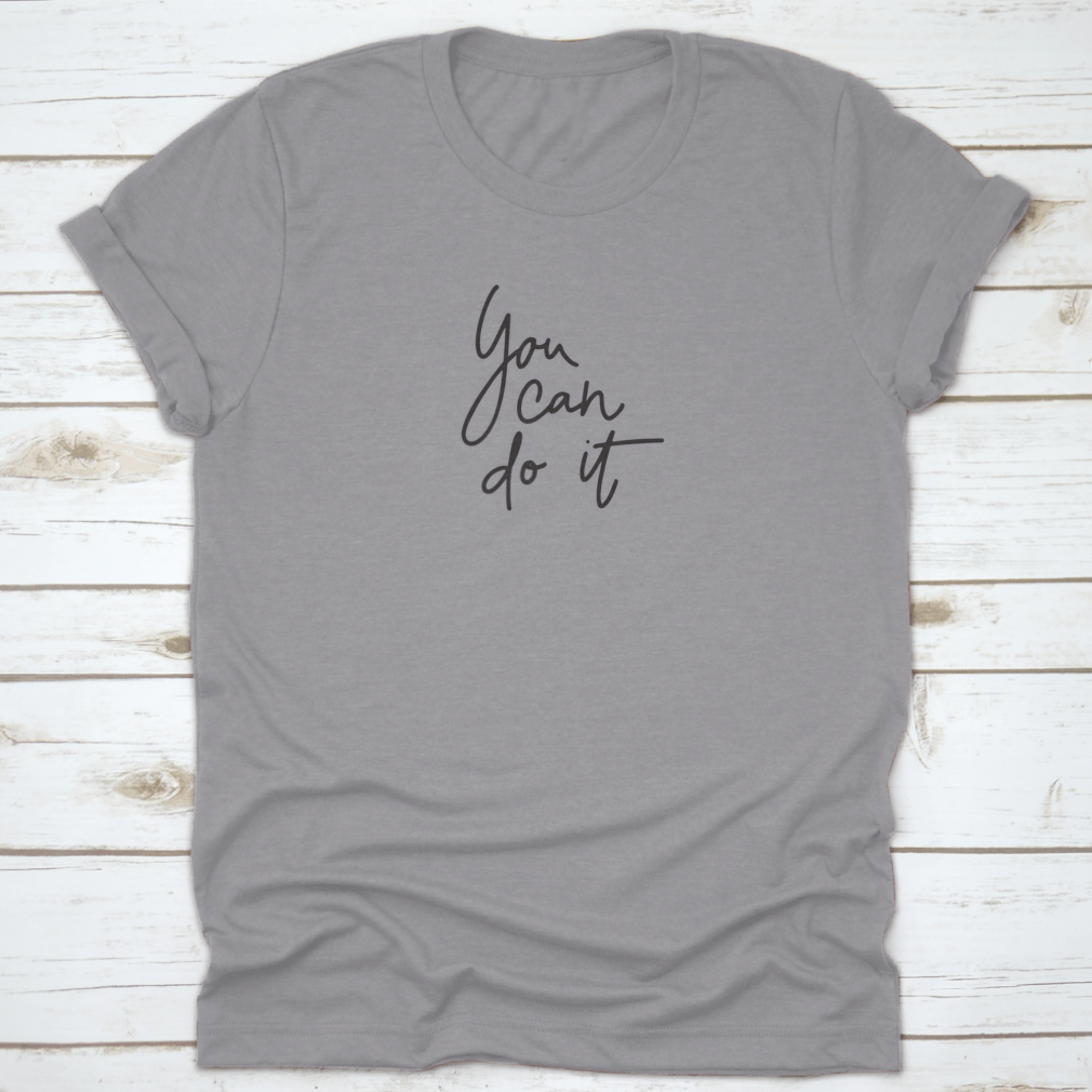 A stylish T-shirt featuring the inspirational quote 'You Can Do It' in hand lettering, made from soft cotton fabric.