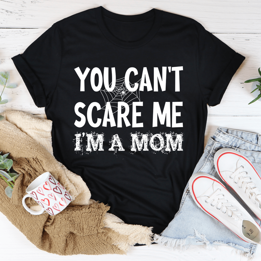 A black Halloween tee featuring the phrase 'You Can't Scare Me I'm A Mom' in bold white letters, made from 100% soft cotton.
