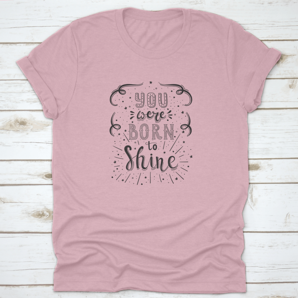 A stylish T-shirt featuring the motivational quote 'You Were Born To Shine' in a vibrant design, made from soft cotton fabric.