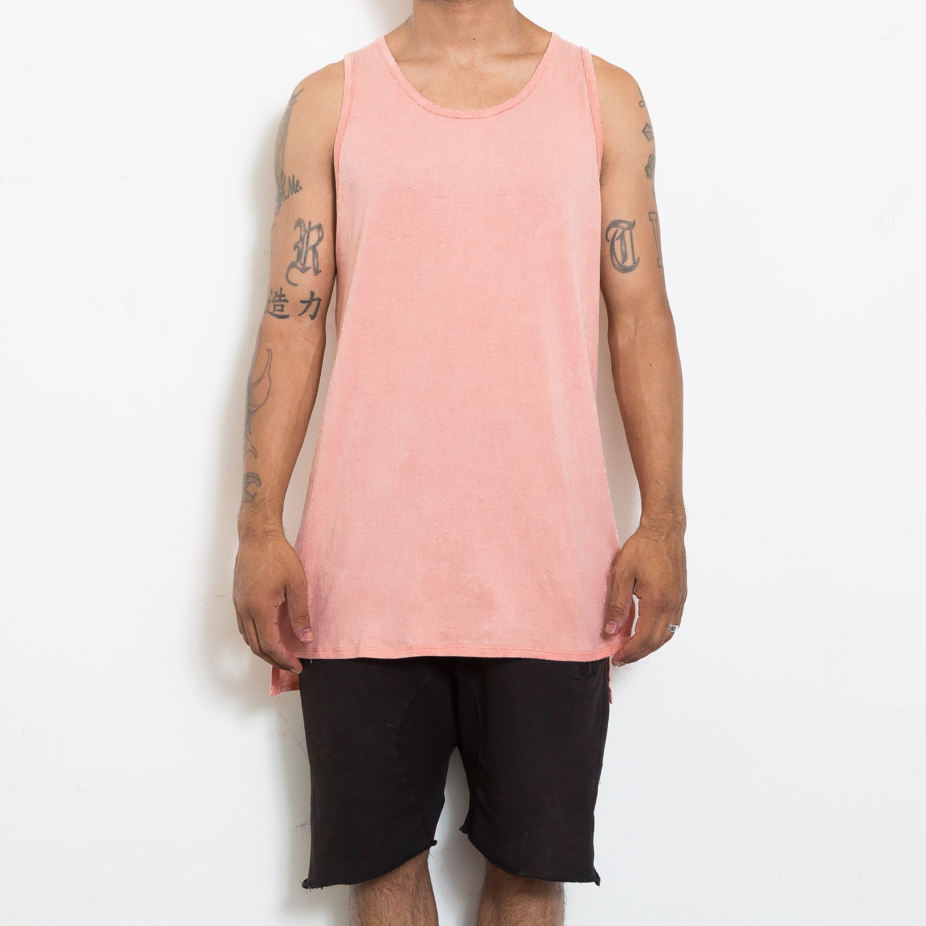 A stylish BASIC TANK in a soft fabric featuring a hi-low design and short side slits, perfect for layering and casual wear.