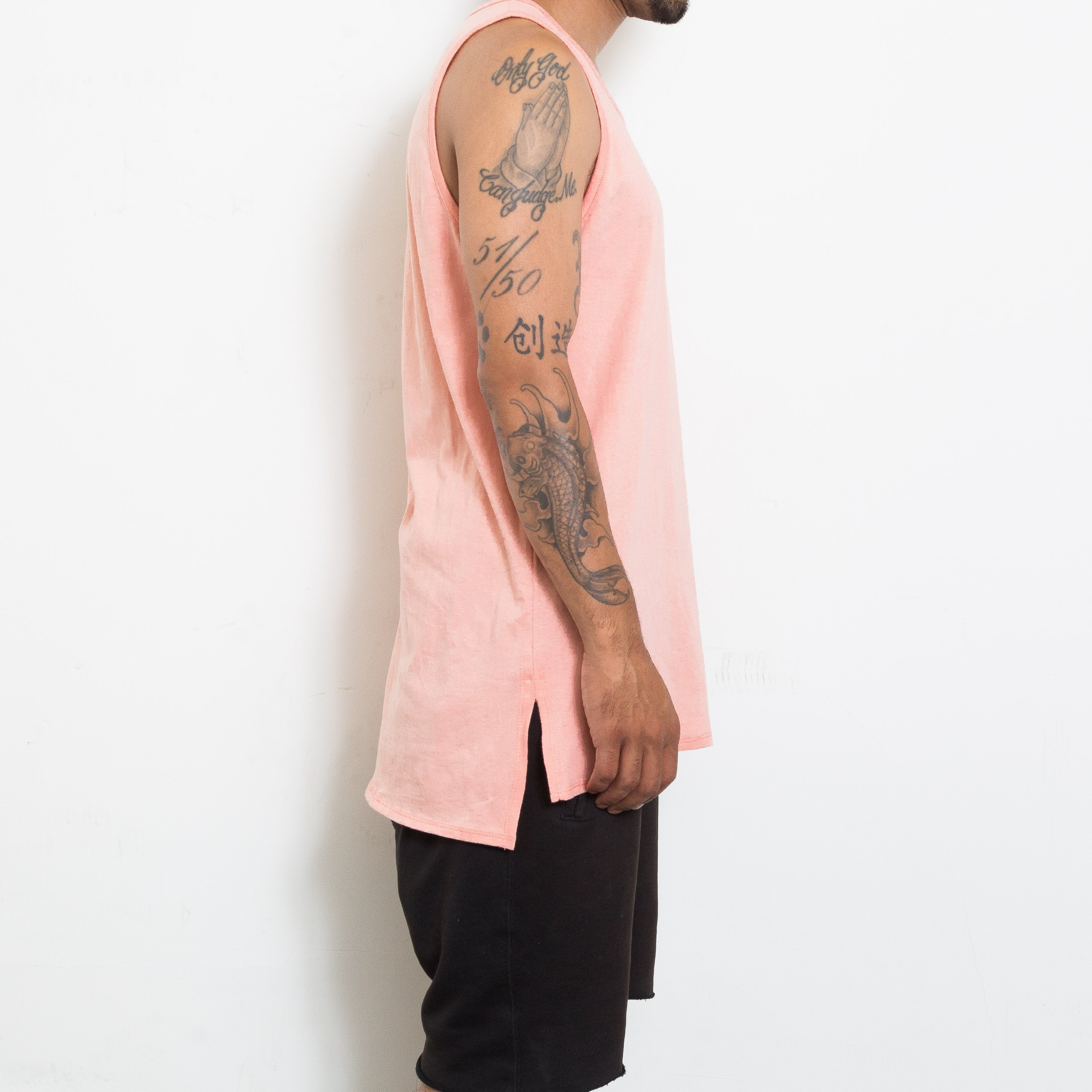 A stylish BASIC TANK in a soft fabric featuring a hi-low design and short side slits, perfect for layering and casual wear.