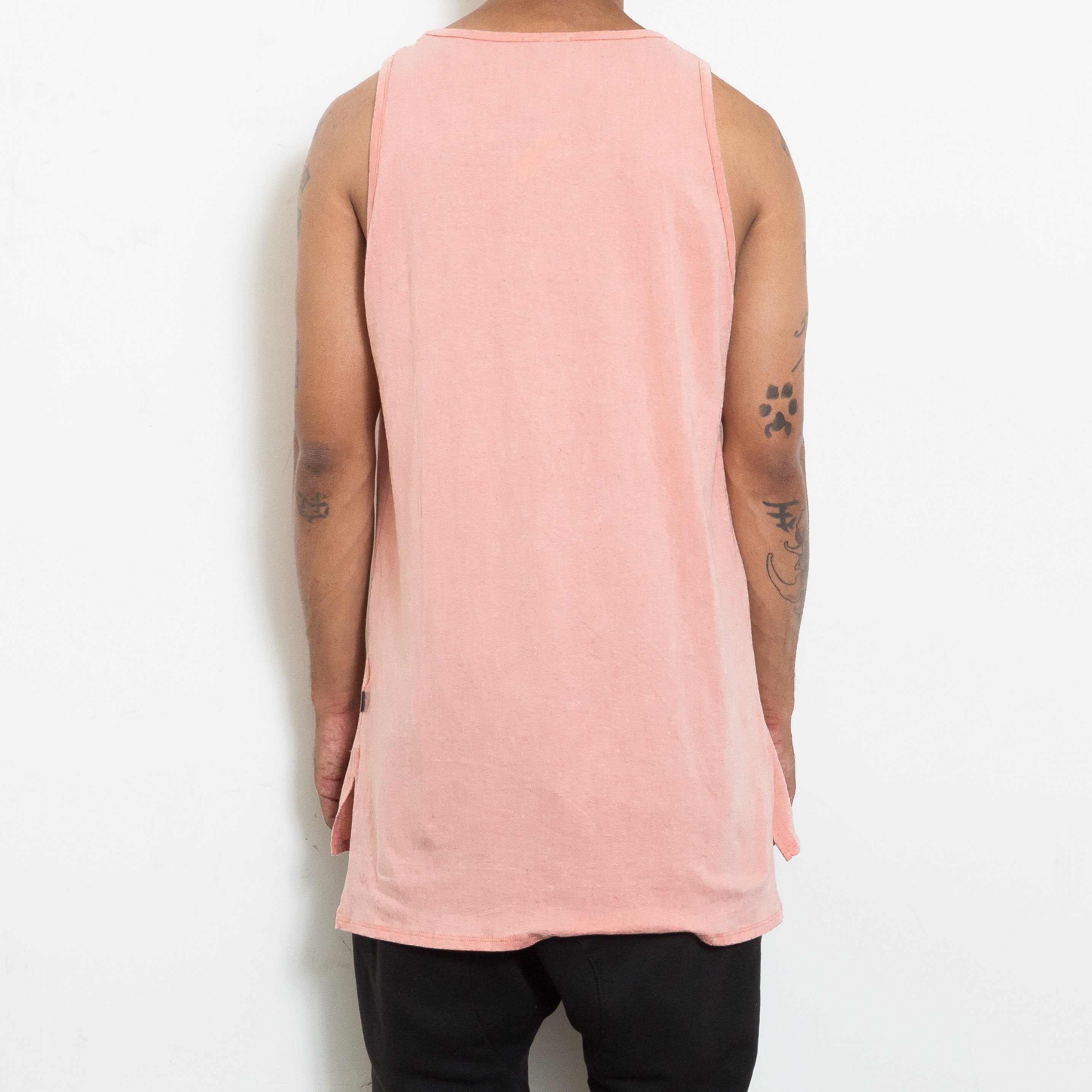A stylish BASIC TANK in a soft fabric featuring a hi-low design and short side slits, perfect for layering and casual wear.