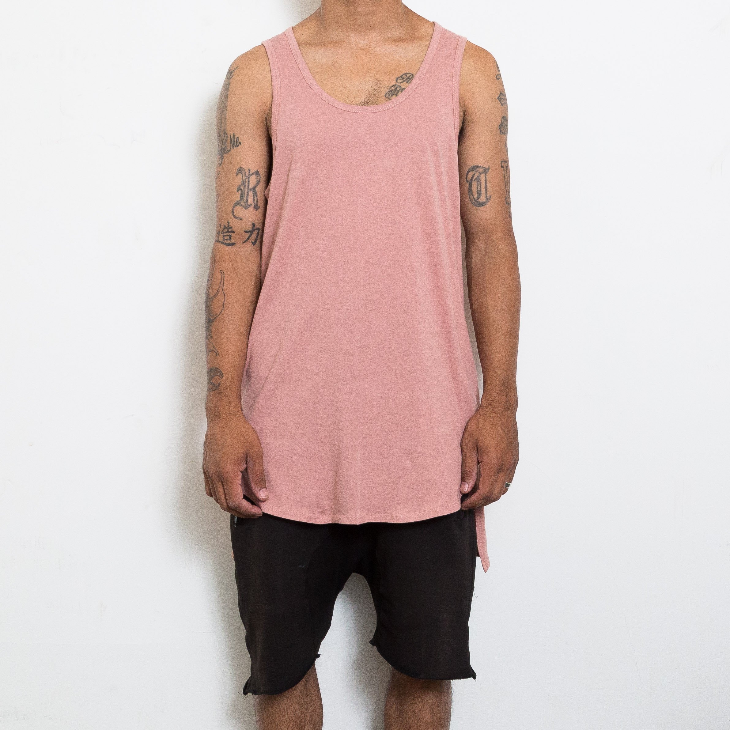 Peach HI LOW TANK featuring a trendy hi-lo design and muscle tank style, perfect for casual wear.