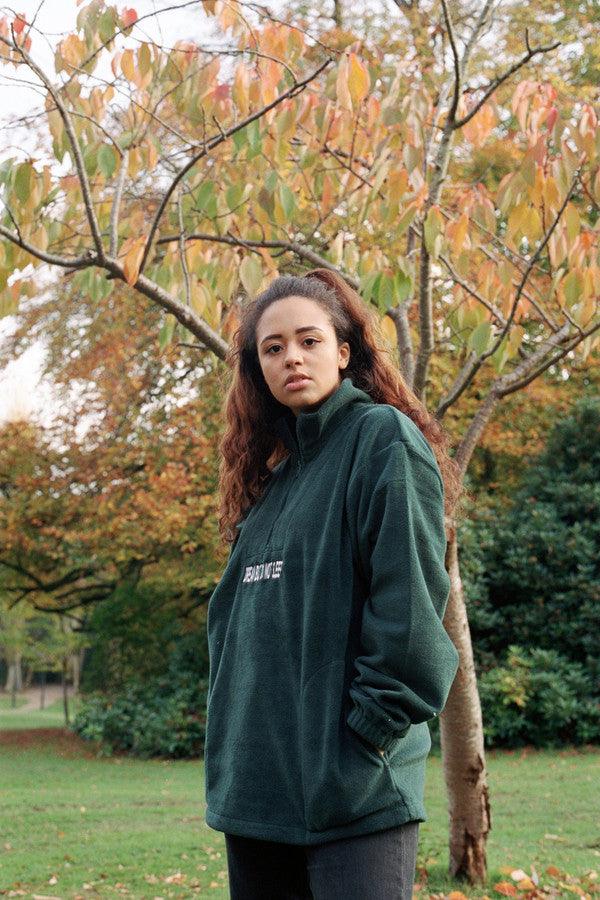 Forest Green fleece sweatshirt featuring 'Dream But Do Not Sleep' embroidered design on the front, showcasing its cozy and stylish appeal.