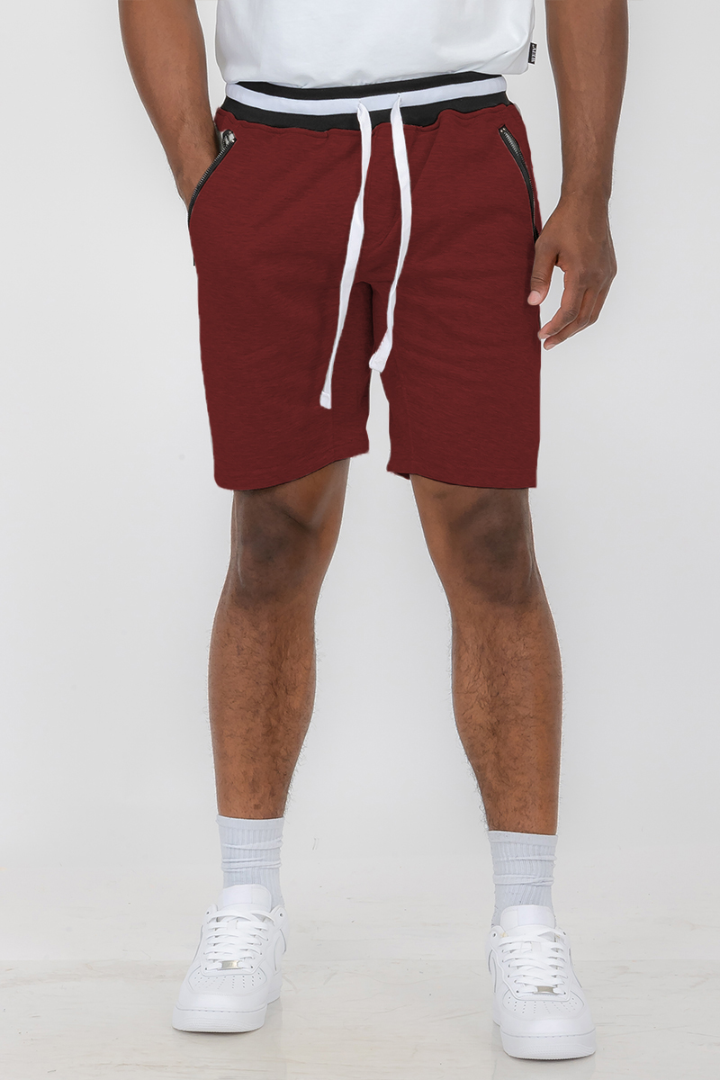 A pair of French Terry Sweat Shorts featuring an elastic waistband and drawstring, made from a soft polyester and spandex blend, with standard pockets.