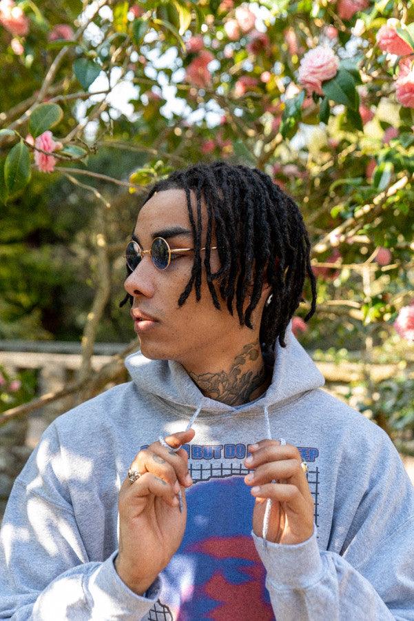 Heavyweight grey hoodie featuring Lost in Motion print, showcasing a relaxed fit and stylish design.