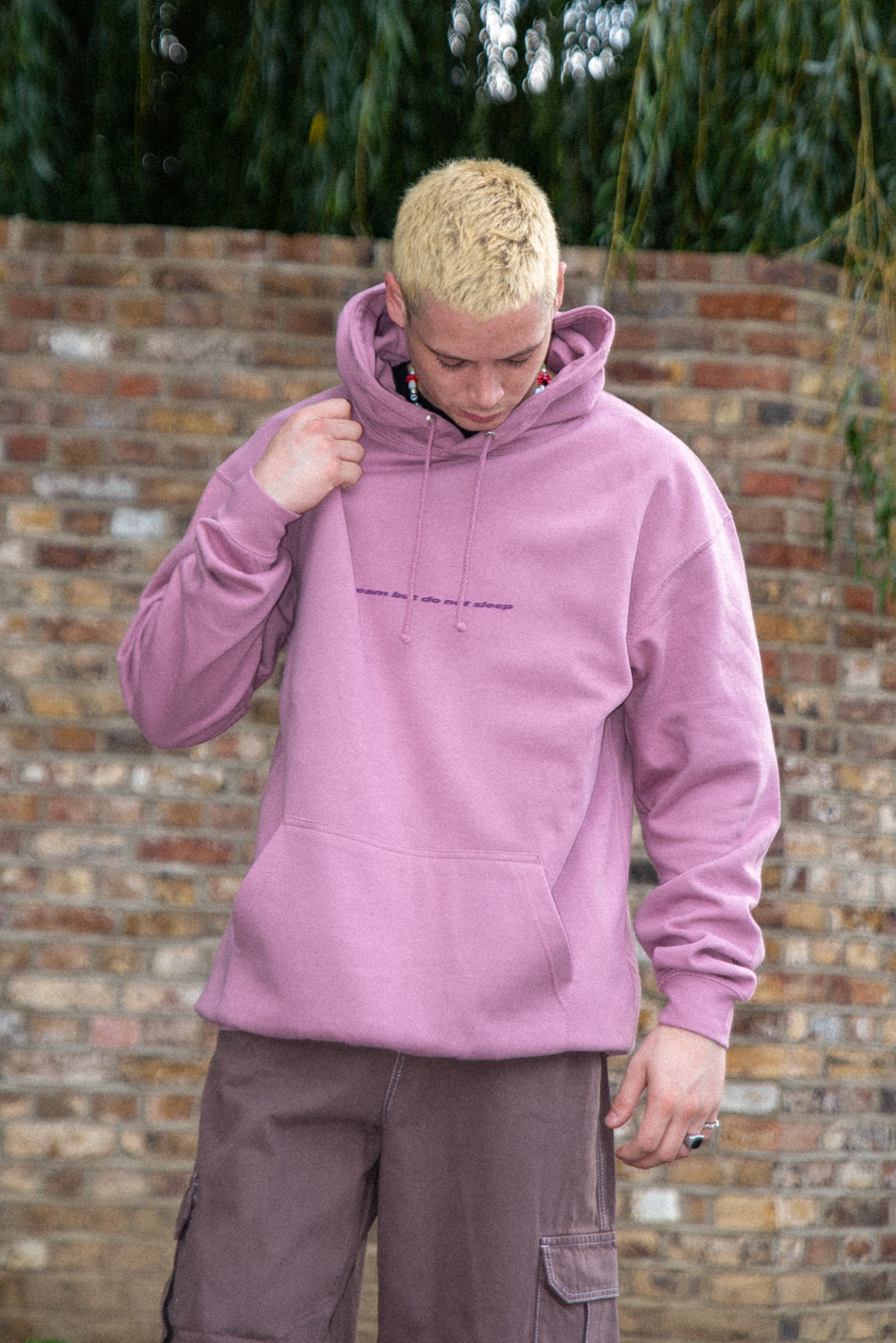 Dusty purple unisex hoodie featuring a minimal logo print, made from heavyweight cotton, displayed on a mannequin.