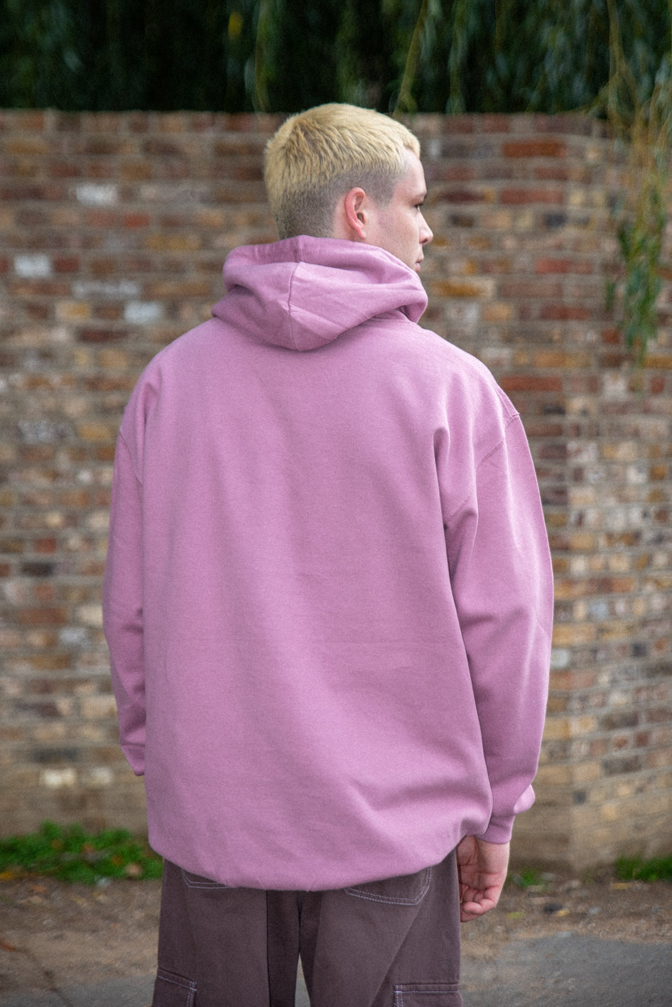 Dusty purple unisex hoodie featuring a minimal logo print, made from heavyweight cotton, displayed on a mannequin.