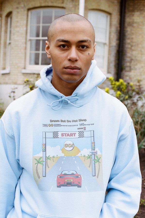 Light blue unisex hoodie featuring a retro Drive In To The Sunset print, perfect for casual wear.