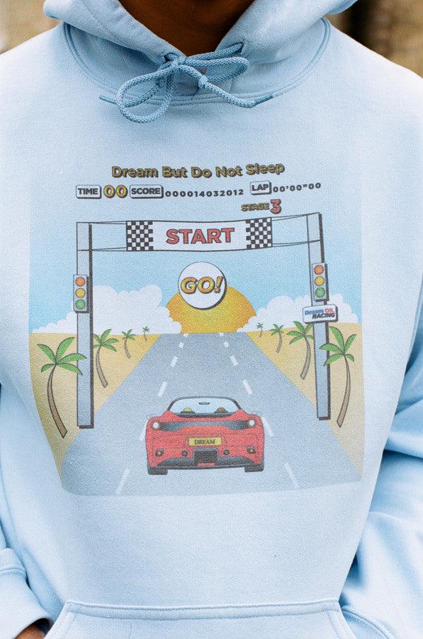 Light blue unisex hoodie featuring a retro Drive In To The Sunset print, perfect for casual wear.