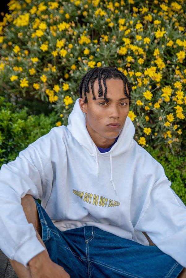 White hoodie featuring a vibrant Vitamin D summer print, showcasing a relaxed fit and stylish design, perfect for summer outings.