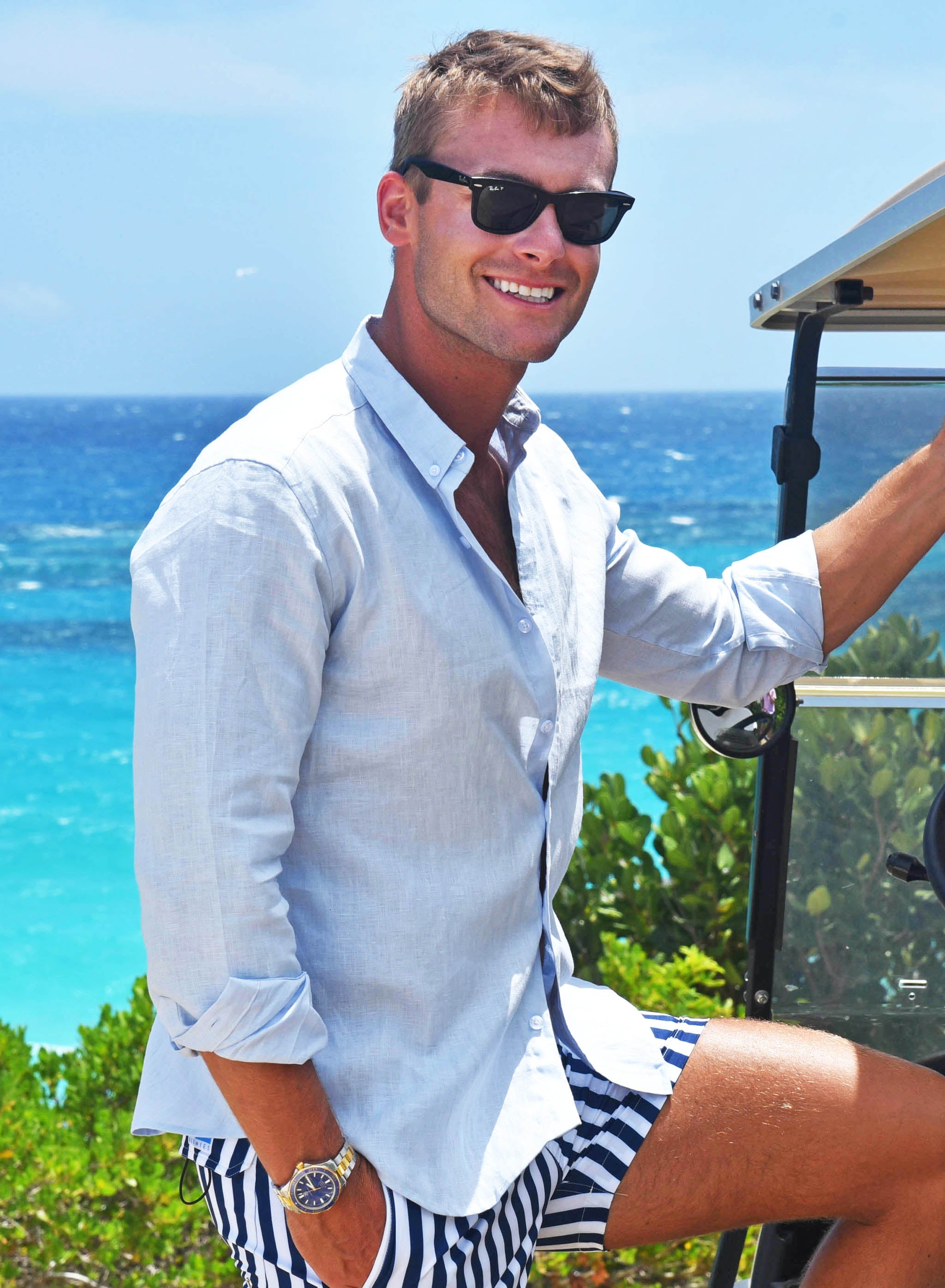 A stylish blue linen shirt with a button-down collar, perfect for summer outings and casual events.