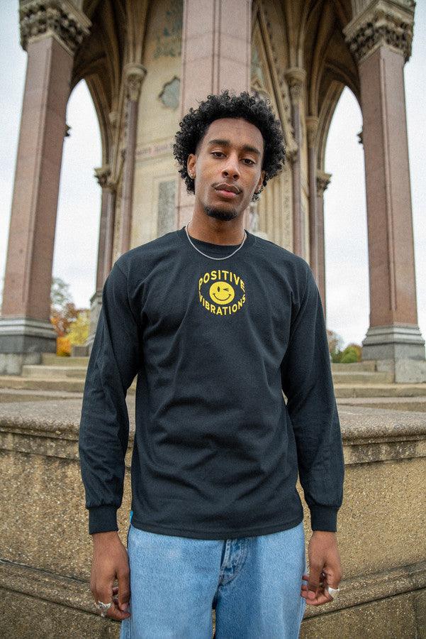 Black long sleeved t-shirt featuring vibrant 90s rave smiley embroidery, made from heavyweight cotton for comfort.