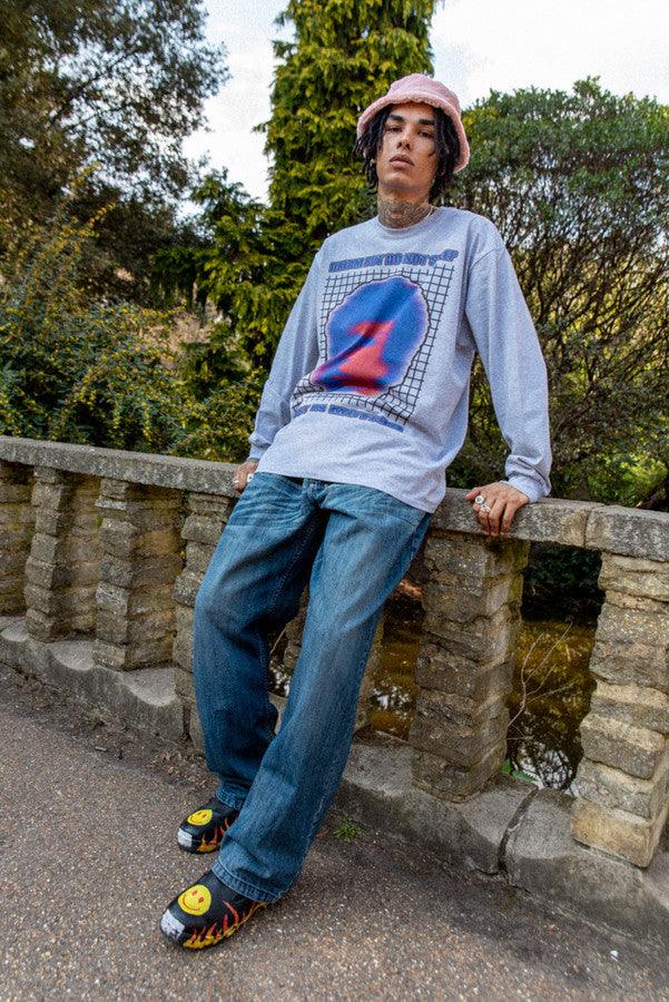 Grey long sleeved t-shirt featuring a Lost in Motion print, showcasing a relaxed fit and heavyweight cotton material.