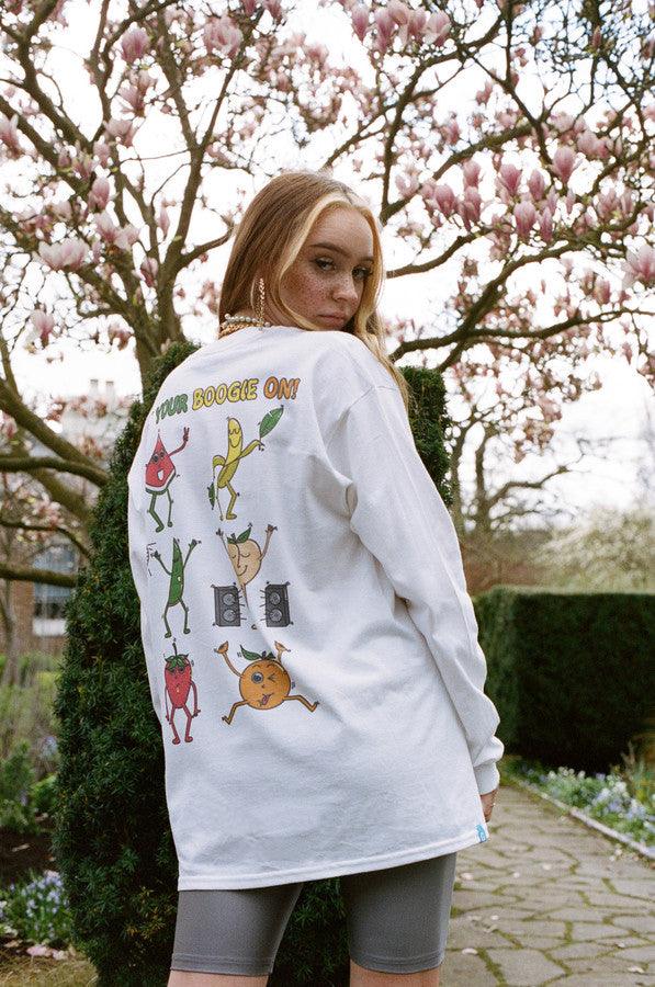 Long sleeved white t-shirt featuring colorful fruity ravers print with characters like watermelon, banana, and strawberry, perfect for festivals.