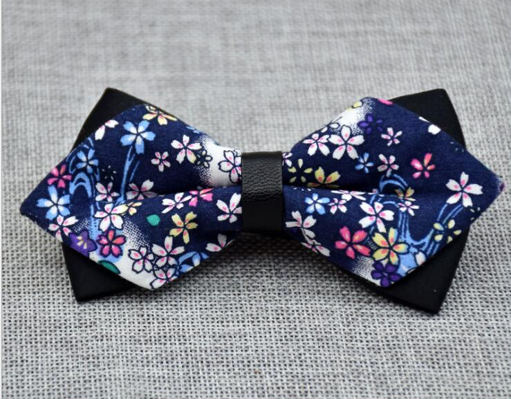 Men's navy blue pre-tied bow tie featuring a colorful floral pattern, made from 100% cotton, elegantly displayed in protective packaging.