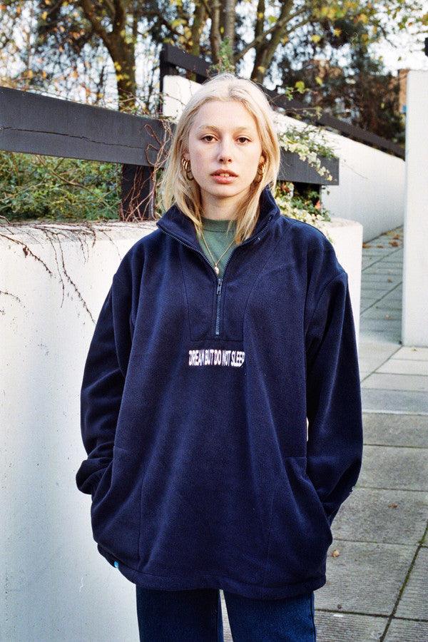 Navy blue fleece sweatshirt featuring 'Dream But Do Not Sleep' embroidered design on the front, showcasing cozy fleece material and relaxed fit.