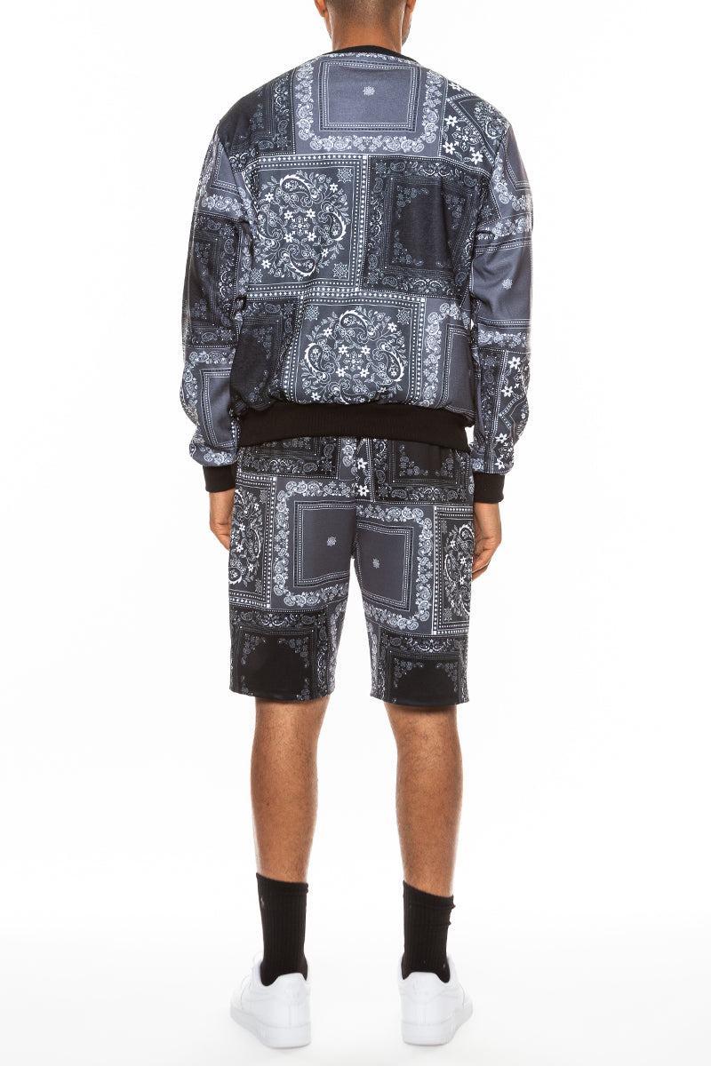 A stylish paisley all over print crew set featuring a round neck, ribbed collar, and cuffs, with front and back pockets.